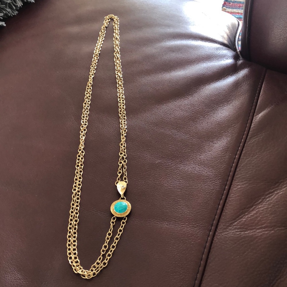 Costume gold necklace with turquoise colored stone